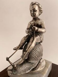 Cupid sitting astride a snail