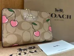 57 新品未使用 coach コーチ 二つ折り財布 がま口 チェリーシグネチャー