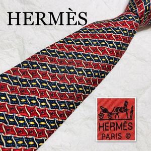 ■美品■HERMES エルメス　ネクタイ　旗　フラッグ　格子　レジメンタルストライプ風　総柄　シルク100% フランス製　レッド×ブラック