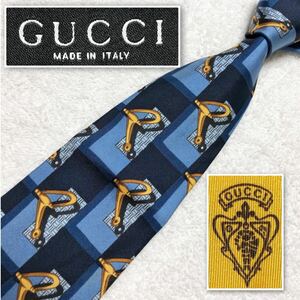 GUCCI グッチ　ネクタイ　あぶみ　長方形　図形　総柄　シルク100% イタリア製　ブルー系　ビジネス